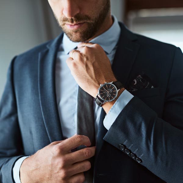man in suit with watch
